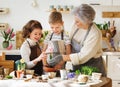 Granny and girls transplanting flowers at home