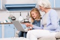 Granny and little girl using laptop Royalty Free Stock Photo