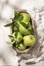 Granny Smith apples in basket. Fresh green fruit on rustic white background Royalty Free Stock Photo