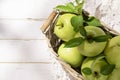 Granny Smith apples in basket. Fresh green fruit on rustic white background Royalty Free Stock Photo