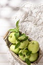 Granny Smith apples in basket. Fresh green fruit on rustic white background Royalty Free Stock Photo