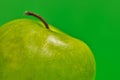 Granny Smith partial apple on green background. Royalty Free Stock Photo