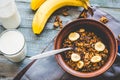 Granola with bananas, nuts, figs and honey, milk, healthy breakf