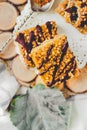 Granola bar cake with date caramel and chocolate. Healthy sweet dessert snack. Cereal granola bar with nuts, fruit and berries on Royalty Free Stock Photo