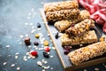 Granola bar with nuts, fruit and berries on black. Royalty Free Stock Photo