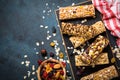 Granola bar with nuts, fruit and berries on black. Royalty Free Stock Photo