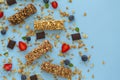 Granola bar. Healthy sweet dessert snack. Dietary food. Cereal granola bar with nuts, fruit and berries on a blue background.