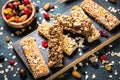 Granola bar with nuts, fruit and berries on black. Royalty Free Stock Photo