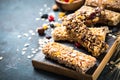 Granola bar with nuts, fruit and berries on black. Royalty Free Stock Photo