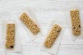 Granola bars on baking sheet over white wooden surface Royalty Free Stock Photo