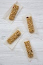 Granola bars on baking sheet over white wooden surface, overhead view. Flat lay, top view, from above. Royalty Free Stock Photo