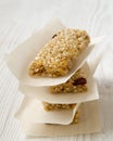 Granola bars on baking sheet over white wooden surface, side view. Royalty Free Stock Photo