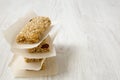 Granola bars on baking sheet over white wooden surface, side view. Royalty Free Stock Photo