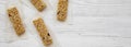 Granola bars on baking sheet over white wooden surface, top view. Flat lay, overhead, from above. Copy space Royalty Free Stock Photo