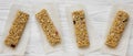 Granola bars on baking sheet over white wooden surface, top view Royalty Free Stock Photo