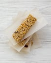 Granola bars on baking sheet over white wooden surface, top view. Overhead Royalty Free Stock Photo