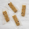 Granola bars on baking sheet over white wooden surface, top view. Overhead, flat lay Royalty Free Stock Photo