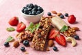 Granola bars and bowl with blueberry on background, closeup Royalty Free Stock Photo