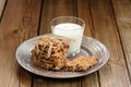 Granola bars with glass of milk on wooden background Royalty Free Stock Photo