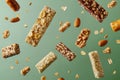 Granola bars and nut clusters floating on green background Royalty Free Stock Photo