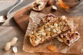 Granola bars with nuts and dried fruits and honey on wooden background- snack for healthy still live