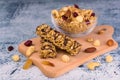 Granola bars and granola in a plate with nuts, berries and raisins on a wooden board. The concept of healthy and dietary breakfast Royalty Free Stock Photo