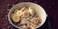 Granola bowl with banana, raisins and nuts closeup