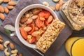 Granola cereal flakes with dried fruit, nuts in green bowl on gray wooden table. Top view. Royalty Free Stock Photo