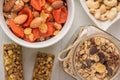 Granola cereal flakes with dried fruit, nuts in green bowl on white wooden table. Top view. Royalty Free Stock Photo