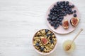 Granola with fruits and honey over white wooden surface, top view. Flat lay, from above, top view Royalty Free Stock Photo