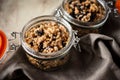 Granola in a glass jar on a grey napkin