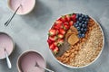 Granola, berries, nuts, chia and yogurt in a plate on a gray concrete background. Ingredients for breakfast. Top view Royalty Free Stock Photo