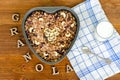 Granola in a heart-shaped baking dish. Yogurt, towel, inscription Granola wooden letters. Food Concept