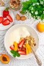 Granola muesli with fruit yogurt, raisins, almonds, fresh berries