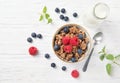 Granola muesli, milk and ripe blueberries and raspberries, healthy breakfast concept, wooden background, top view Royalty Free Stock Photo