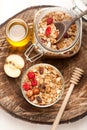 Granola with nuts, dried fruit and honey on wooden background Royalty Free Stock Photo