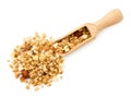 Granola with nuts spilled from a wooden scoop on a white. The view of the top. Royalty Free Stock Photo