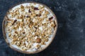 Granola with oatmeal, dried fruit, honey, raisins, dry cranberry, almond and cashew nuts with yogurt in a coconut bowl, close up Royalty Free Stock Photo