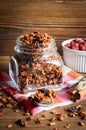 Granola in open glass jar and wild strawberries