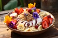 Granola in a plate with yogurt and fruit, strawberries, banana