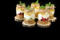 Granola, slices of different fresh fruits and berries, yogurt, honey in jars isolated on black background. Royalty Free Stock Photo