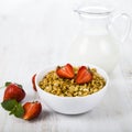 Granola with strawberry and a jug of milk Royalty Free Stock Photo