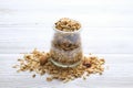 Granola superfood with almond and cashew nuts, dry fruits, raisins cherry in the ceramic jar on the white wooden table, top view, Royalty Free Stock Photo