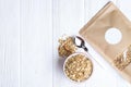 Granola superfood with almond and cashew nuts, dry fruits, raisins cherry in the ceramic jar on the white wooden table, top view, Royalty Free Stock Photo
