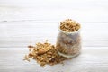 Granola superfood with almond and cashew nuts, dry fruits, raisins cherry in the glass jar on the white wooden table, top view, br Royalty Free Stock Photo