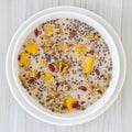 Granola with yellow mango, red goji berries and almond milk, closeup Royalty Free Stock Photo