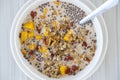 Granola with yellow mango, red goji berries and almond milk, closeup Royalty Free Stock Photo