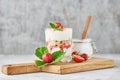 granola or yogurt with strawberry in glass, fresh berries and jar with sugar on a cutting board Royalty Free Stock Photo