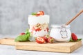 granola or yogurt with strawberry in glass, fresh berries and jar with sugar on a cutting board Royalty Free Stock Photo