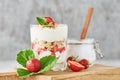 Granola or yogurt with strawberry in glass, fresh berries and jar with sugar on a cutting board Royalty Free Stock Photo